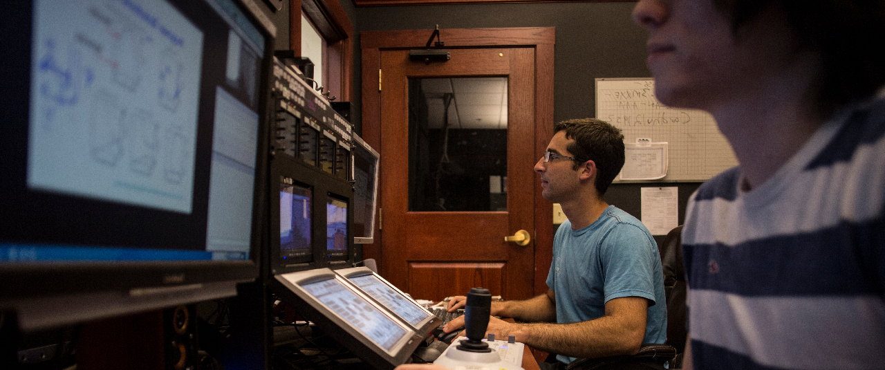 Students monitor distance education classrooms.